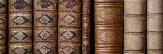 Detailed view of classic leather-bound books lined on a shelf.